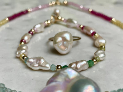 A bracelet featuring white freshwater Keshi pearls set with sterling silver and semi-precious crystals.
