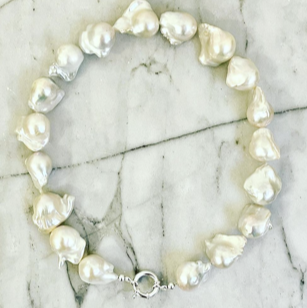 Pearl necklace and earrings set on a marble surface